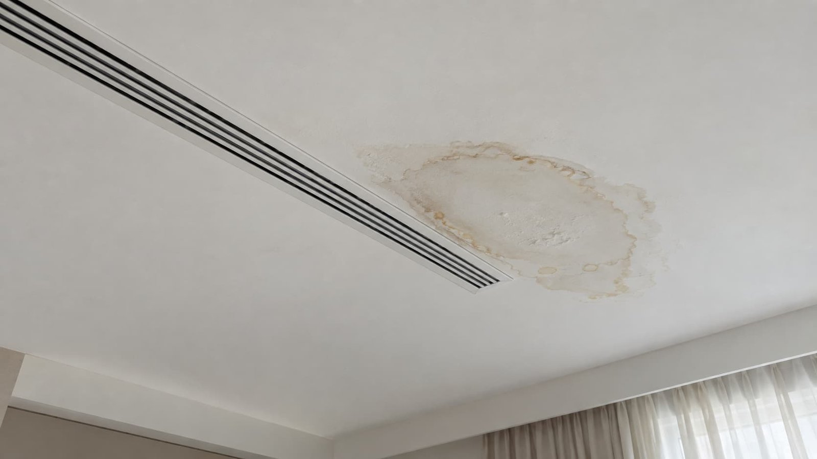 Ceiling water stain caused by a blocked A/C drain line in a Dubai apartment